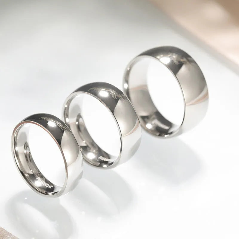 Silver titanium steel ring shown in a minimalist style on a finger, demonstrating its width options.