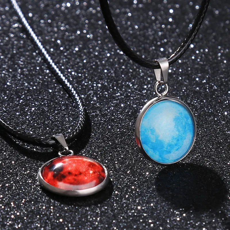 Luminous moon and constellation glass pendant on a silver alloy necklace chain with an extension piece.