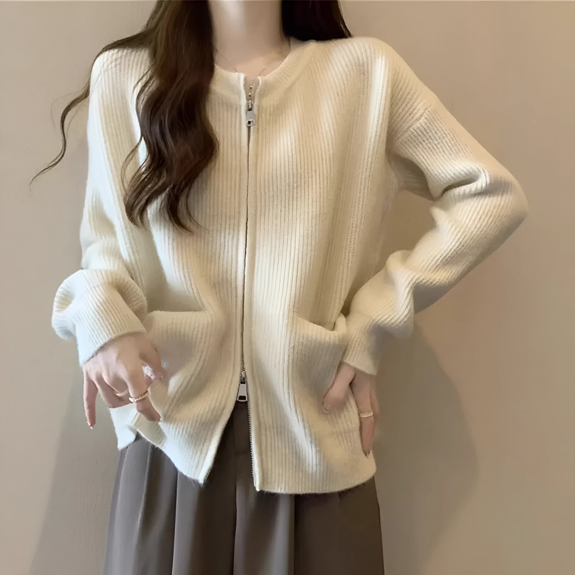 Beige viscose sweater coat cardigan with long sleeves on a hanger.