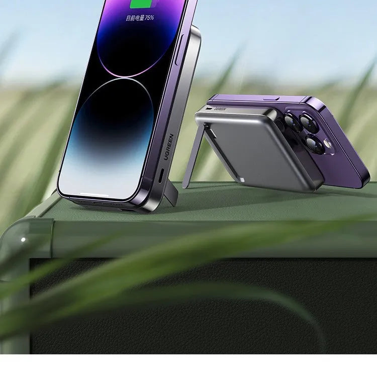 Small black portable magnetic bracket power bank with 10000mAh capacity on a table.