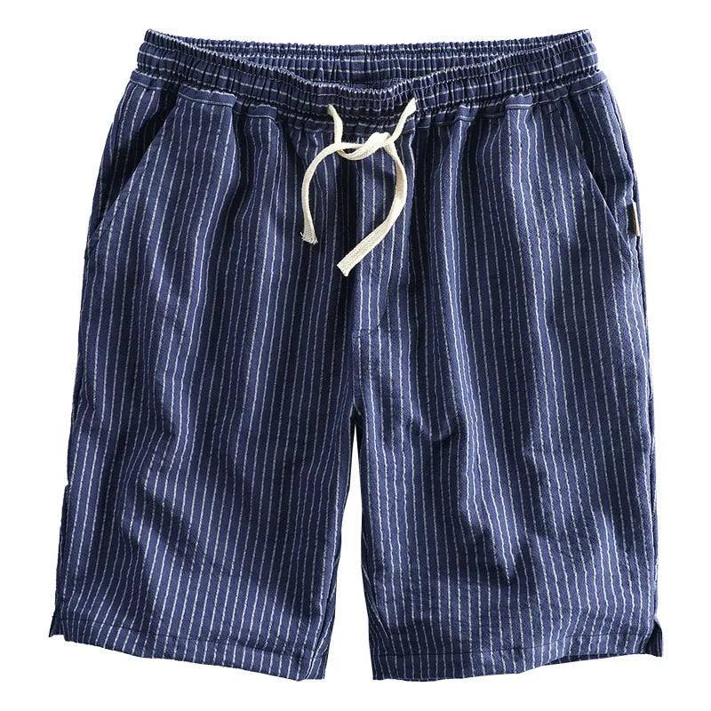 Man wearing striped light grey casual cotton shorts with a straight leg and elastic waistband.