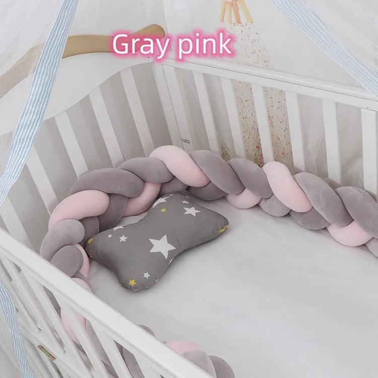 Bendable braid knot baby crib bumper in spandex velvet fabric on a white cot.