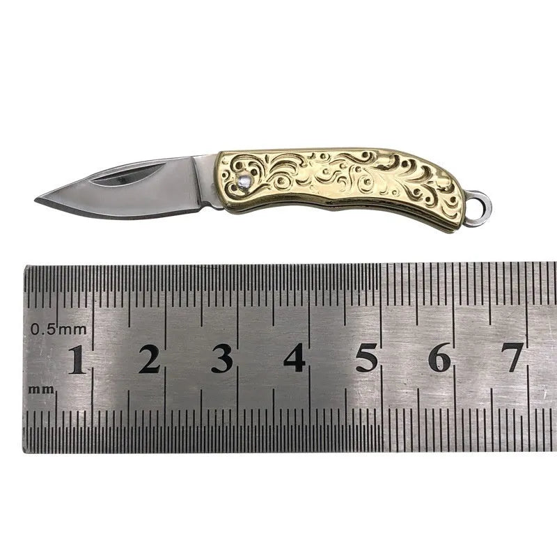 Brass mini folding knife keychain pendant with 3cm blade and 42mm shank on a key ring