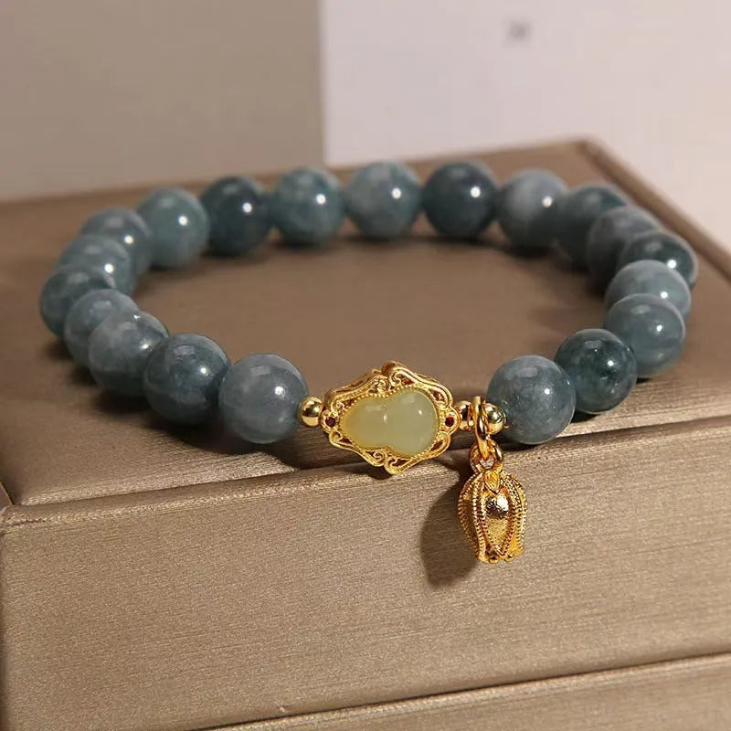 Natural stone bracelet with blue beads, lotus pendant, and adjustable leather strap