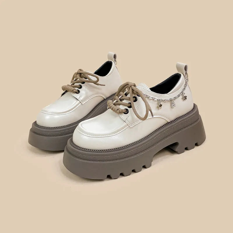 White platform Mary Jane shoes with chunky heel and front lace-up closure
