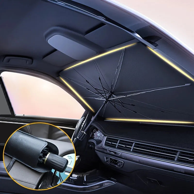Open foldable car windshield sunshade umbrella placed against a car windscreen.