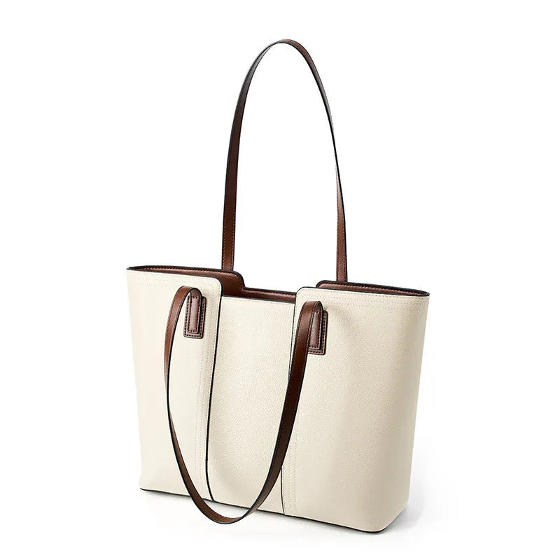 Women's black genuine leather crossbody bag showing horizontal square shape and internal organiser pockets