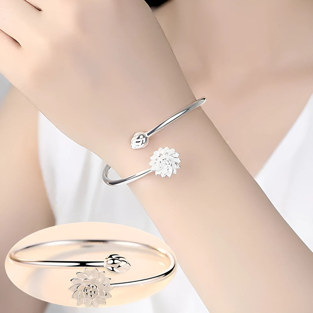 Snow Lotus silver open style bracelet on wrist showing lotus motif and electroplated finish