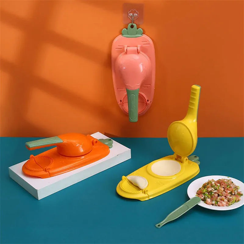 Orange and white plastic manual dumpling press tool with ergonomic handle on a kitchen worktop.