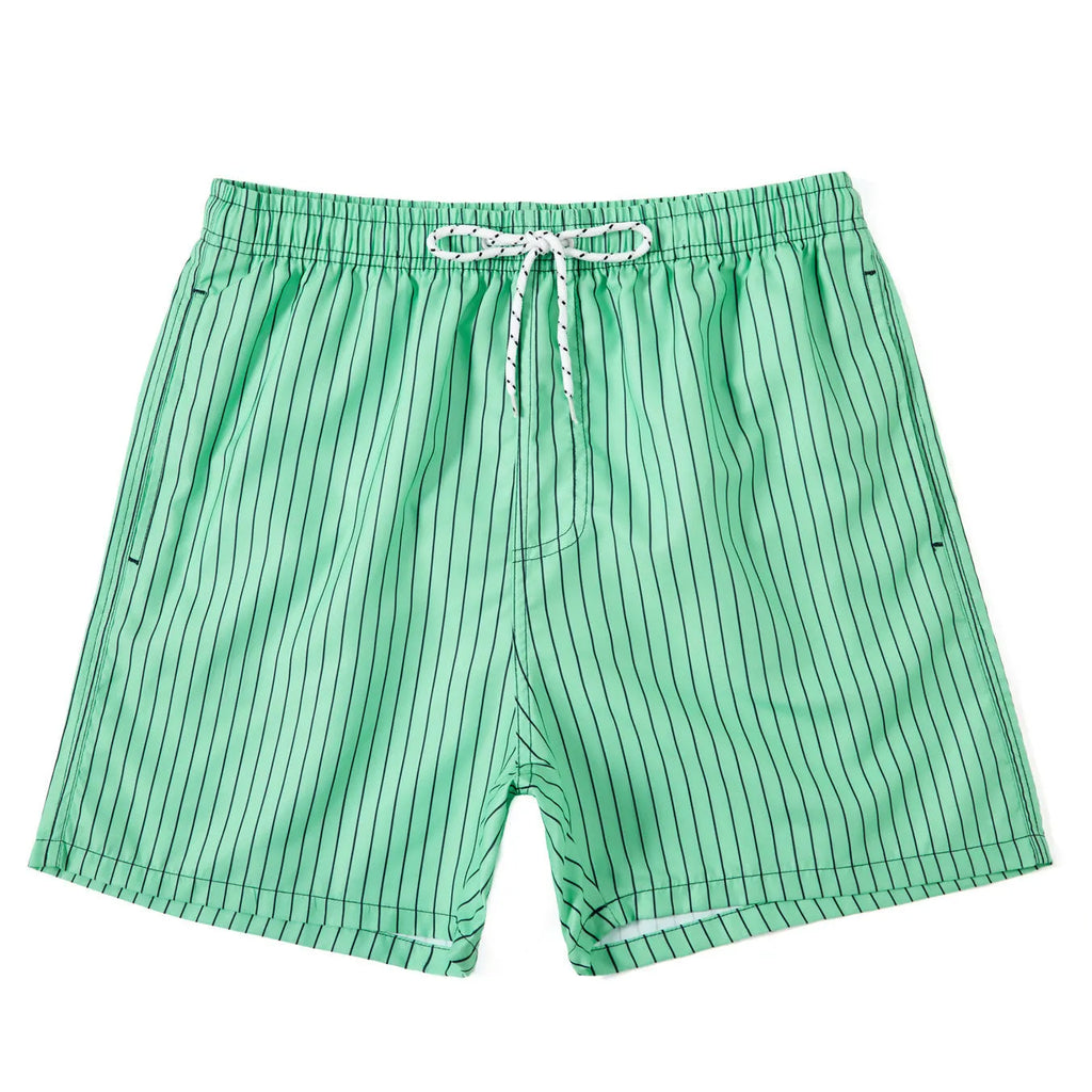 Men's striped polyester shorts in light blue, shown on a beach.