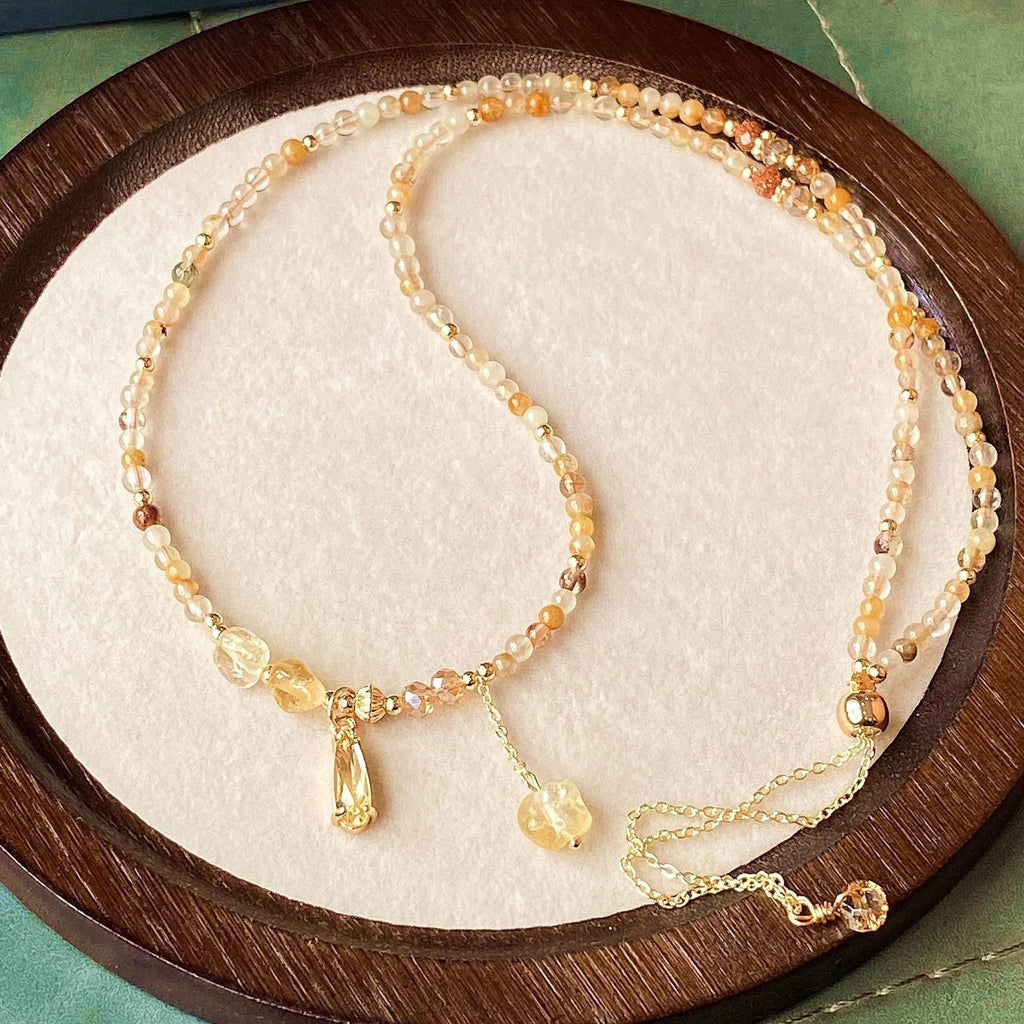 Women's gold natural citrine bracelet with three layered circles and Saturn design details.