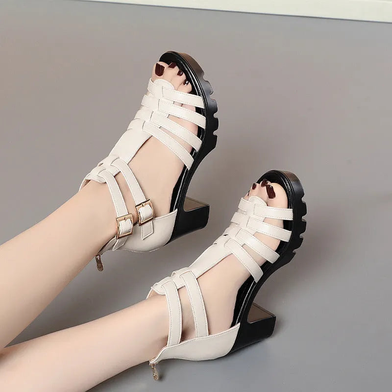 Women's beige summer high heel shoes with hollow-out design and rhinestone decoration on a buckle.