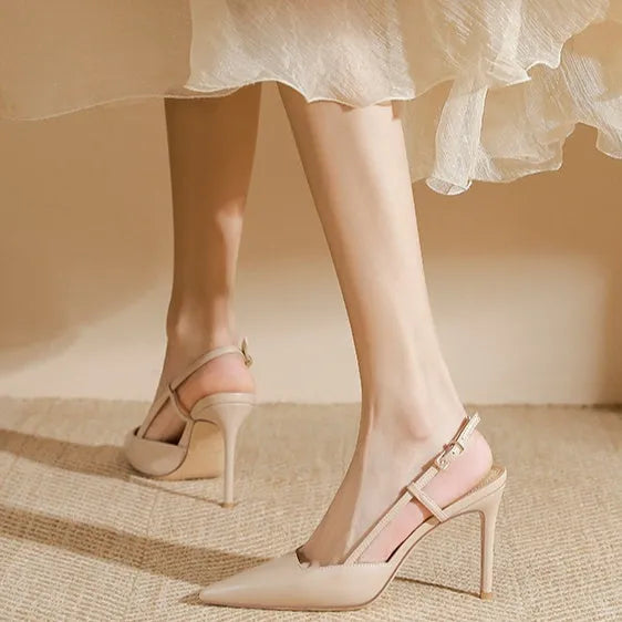 Women's apricot high-heeled sandals with a buckle on the toe strap and thin belts.