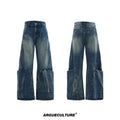 Man wearing loose fit verdant blue retro jeans with a curved knife cut and washed burst pattern.
