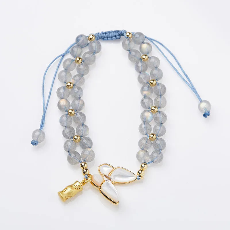 Gray moonstone woven bracelet with geometric design on woven hand rope