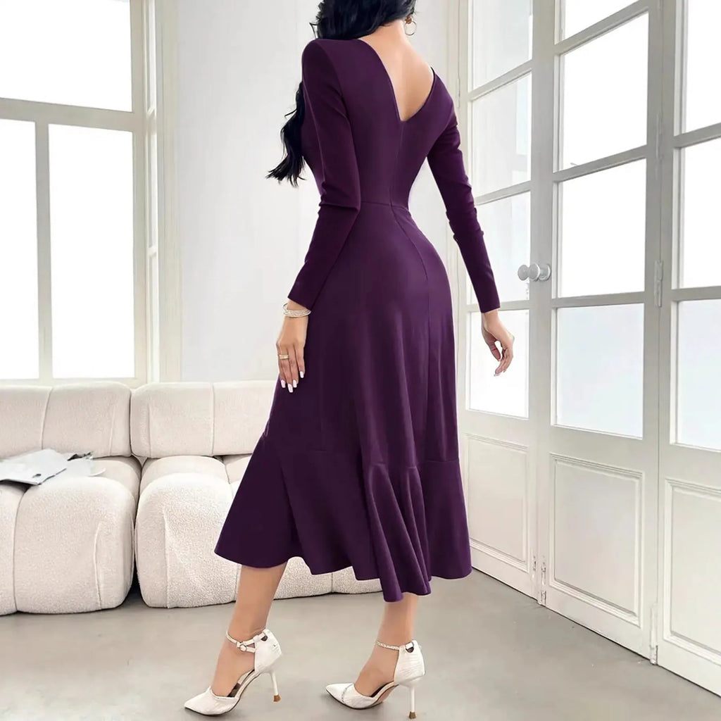 Purple women's long sleeve dress with round neck and ruffle detail on a hanger