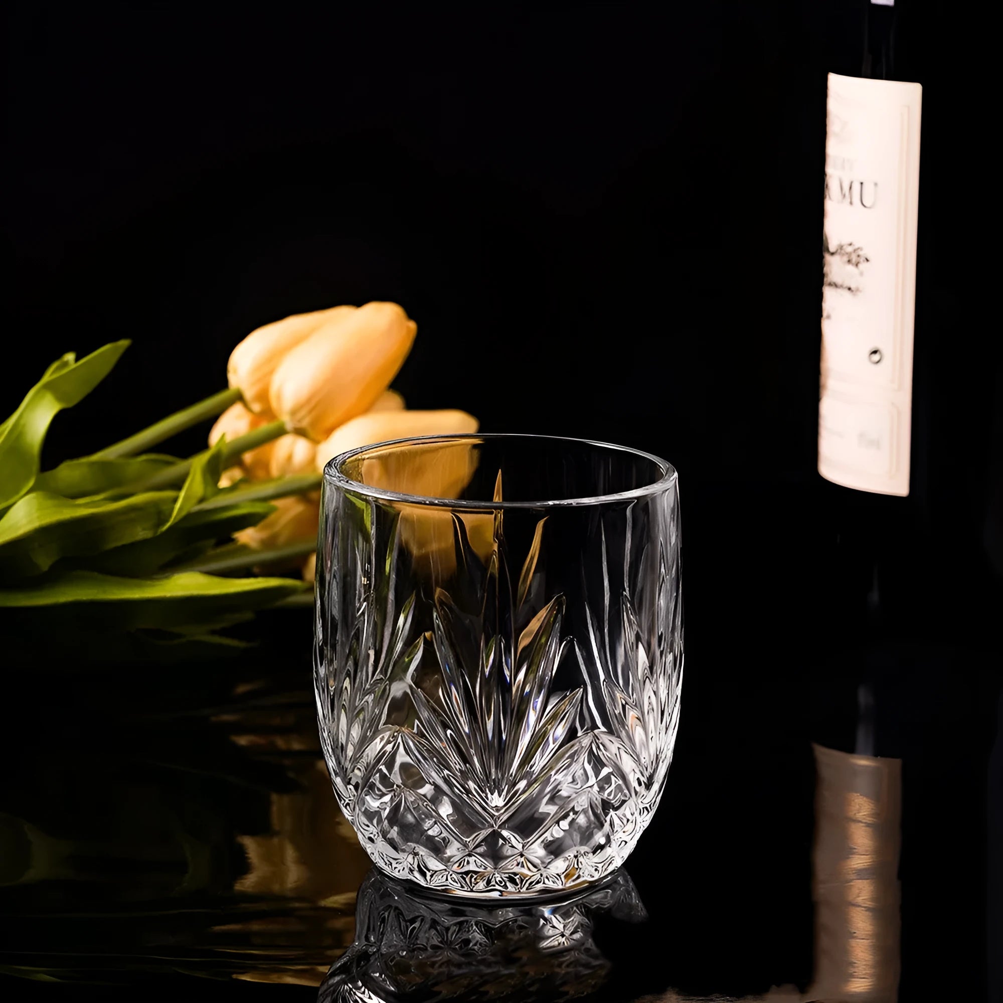 A thick-bottomed crystal whiskey shot glass on a table, shown in one of the available colour options.