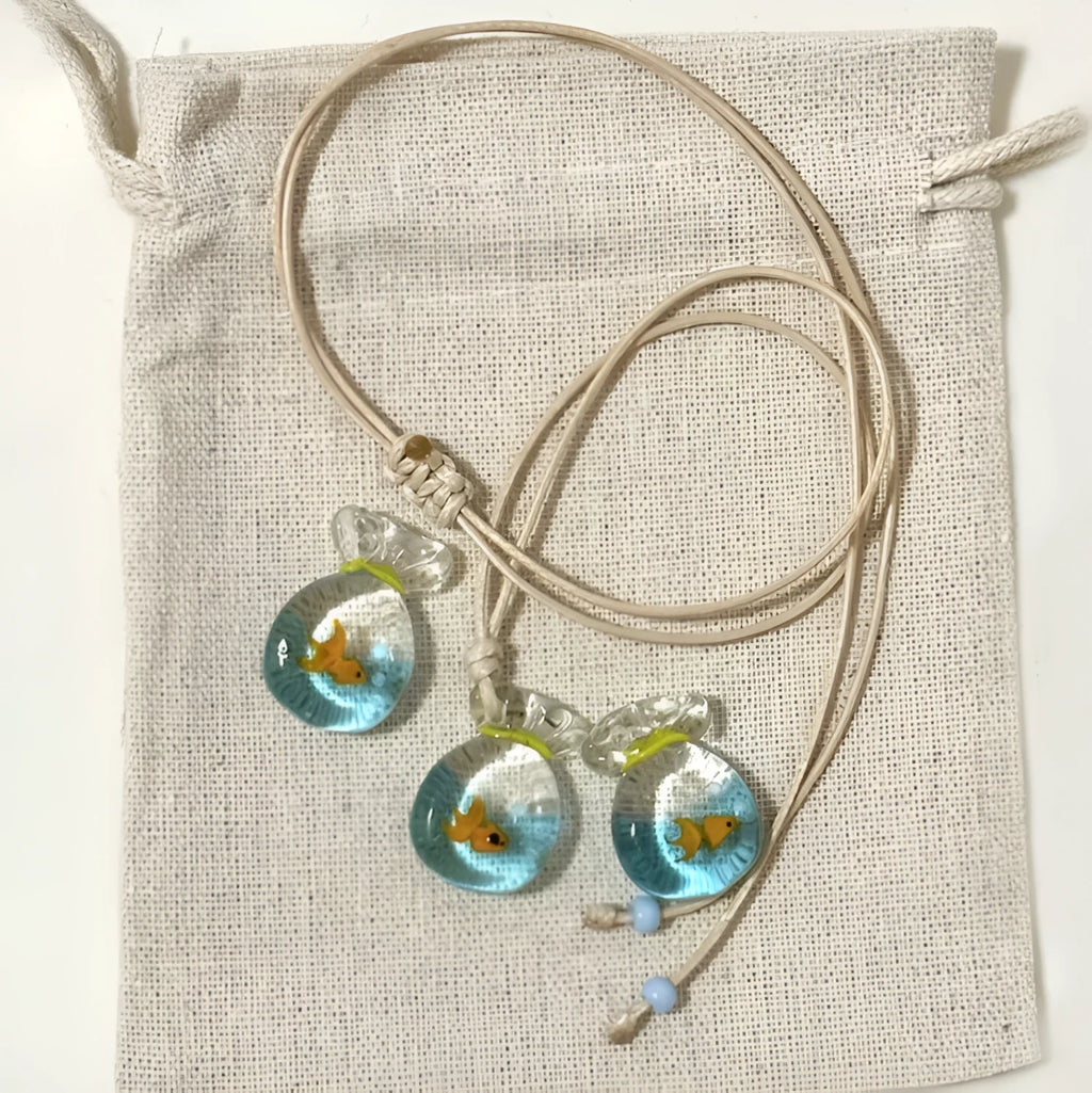 Women's necklace with coloured glaze joker charm on a cotton and linen clavicle chain