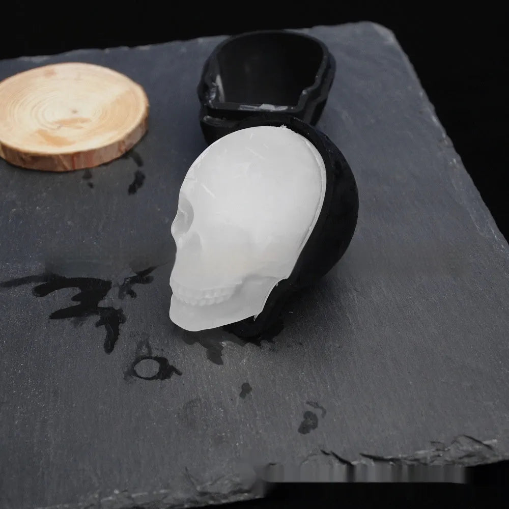 3D Halloween skull ice cube tray made from blue food-grade silicone on a white background.