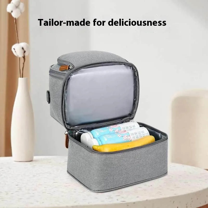 Grey women's thermal insulation backpack made of Oxford cloth with a curved shoulder strap.