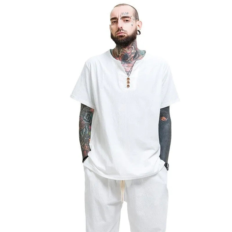 Man wearing a loose apricot coloured cotton short sleeve T-shirt.