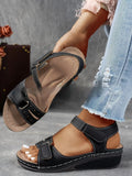 Women's beige strap sandals with a Velcro fastener and thick composite sole, shown in a round toe design.