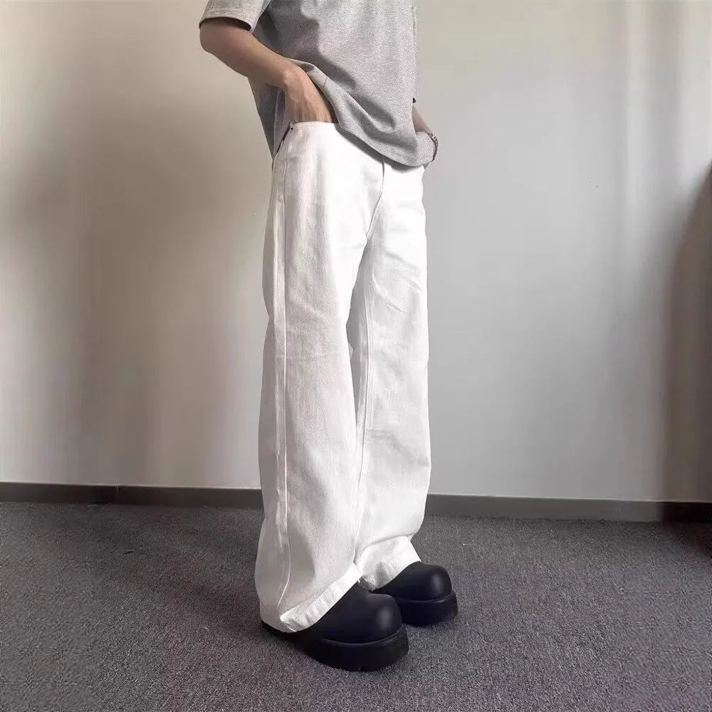 Men's straight leg white denim jeans with a mid waist and wide leg opening.