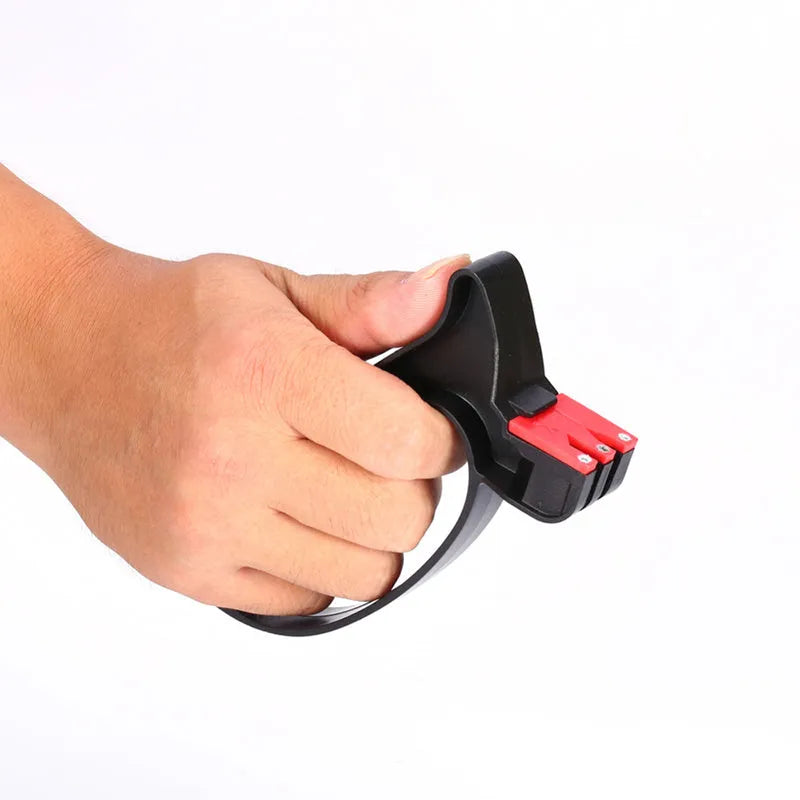 Black handheld knife and scissor sharpener showing ergonomic handle and sharpening slots on a white background.