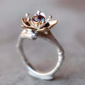 Silver two-tone geometric floral fashion ring for women on a hand.