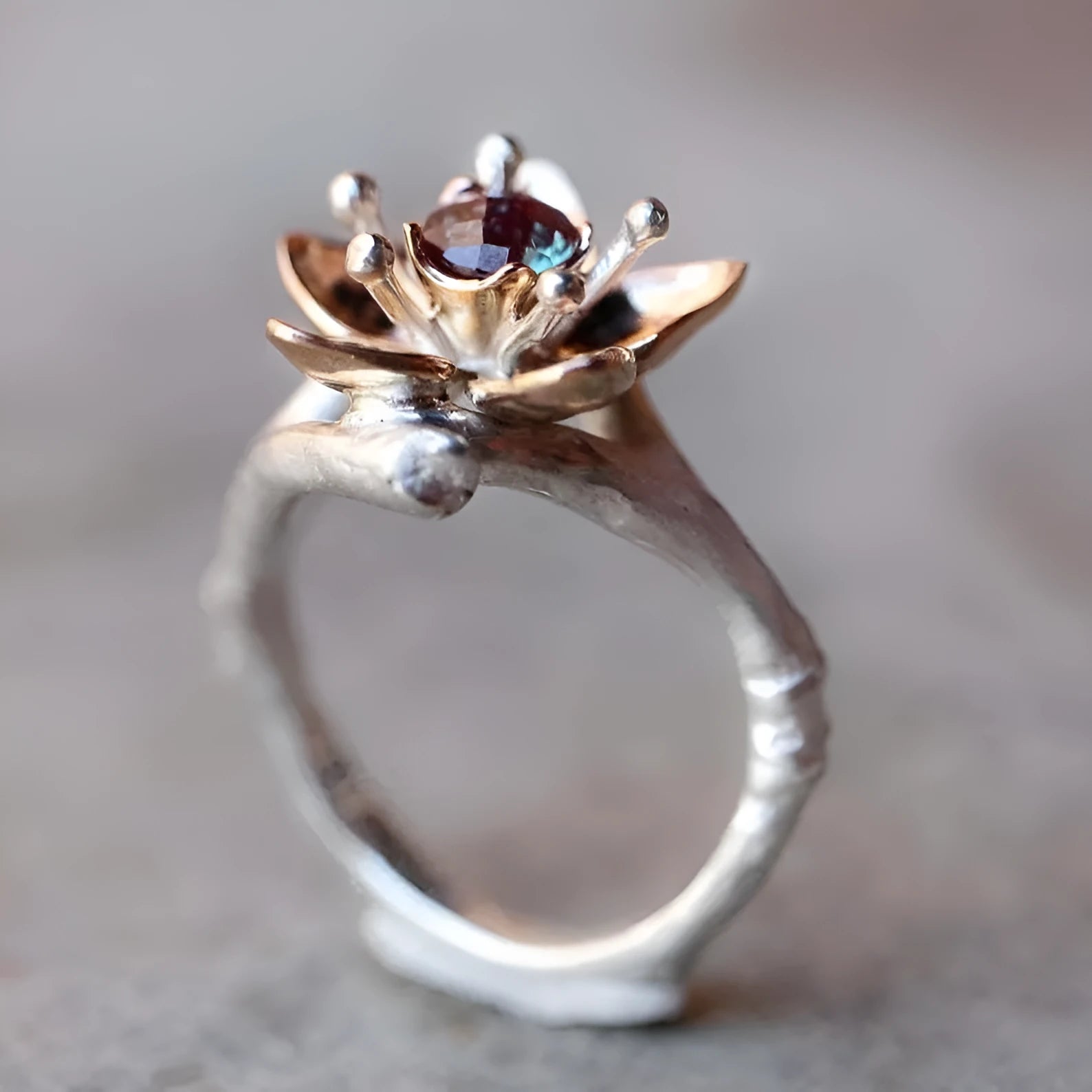 Silver two-tone geometric floral fashion ring for women on a hand.
