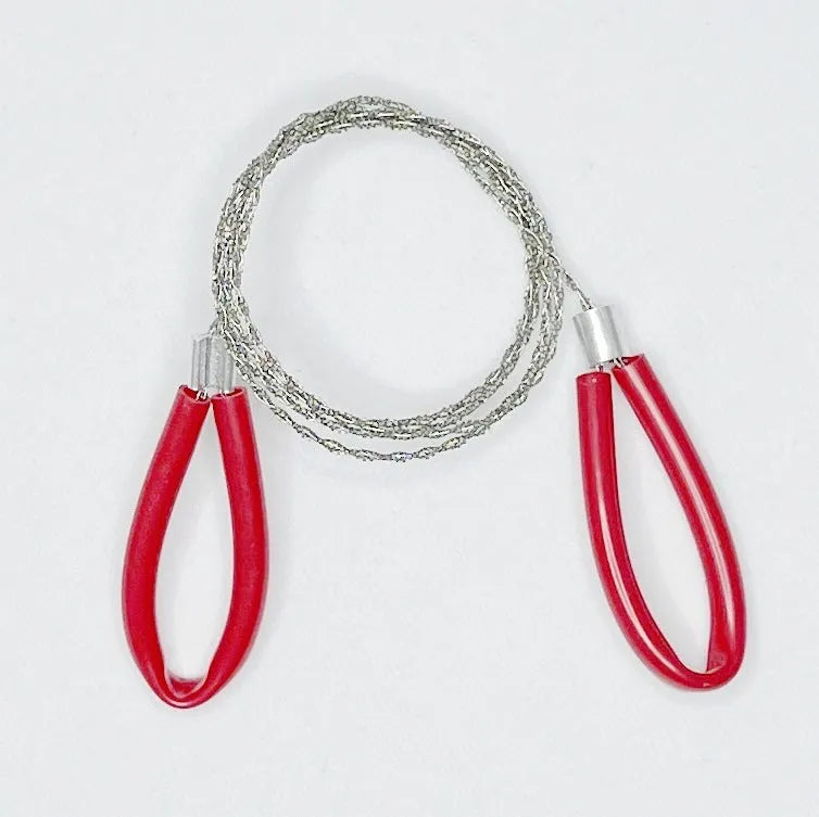 Black and red survival wire saw with leather case on a wooden background, showing its extended length.