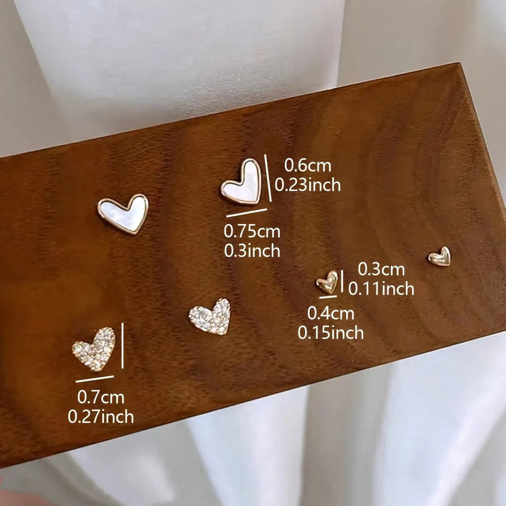 Women's heart shape earrings suit with three pairs in gold, black, black white, and pink colours