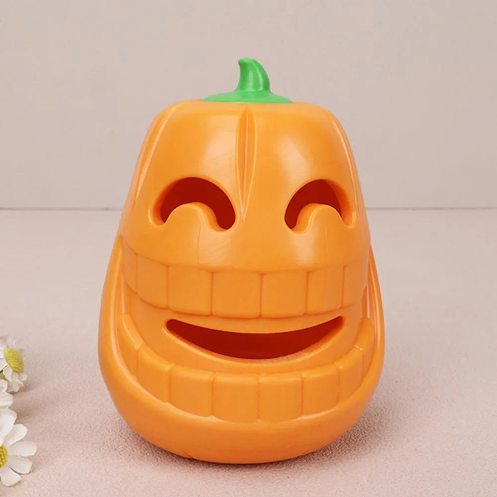 Yellow pumpkin-shaped tough TPR chew toy for dogs on a white background.