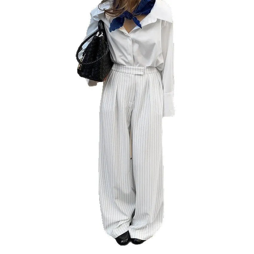 White striped wide-leg casual trousers with a loose fit and zipper detail on a mannequin.