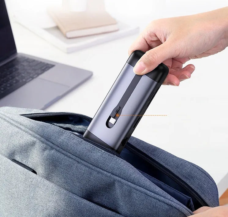 USB-C docking station adapter showing either 5-in-1 or 9-in-1 port configuration on a compact 9cm body.
