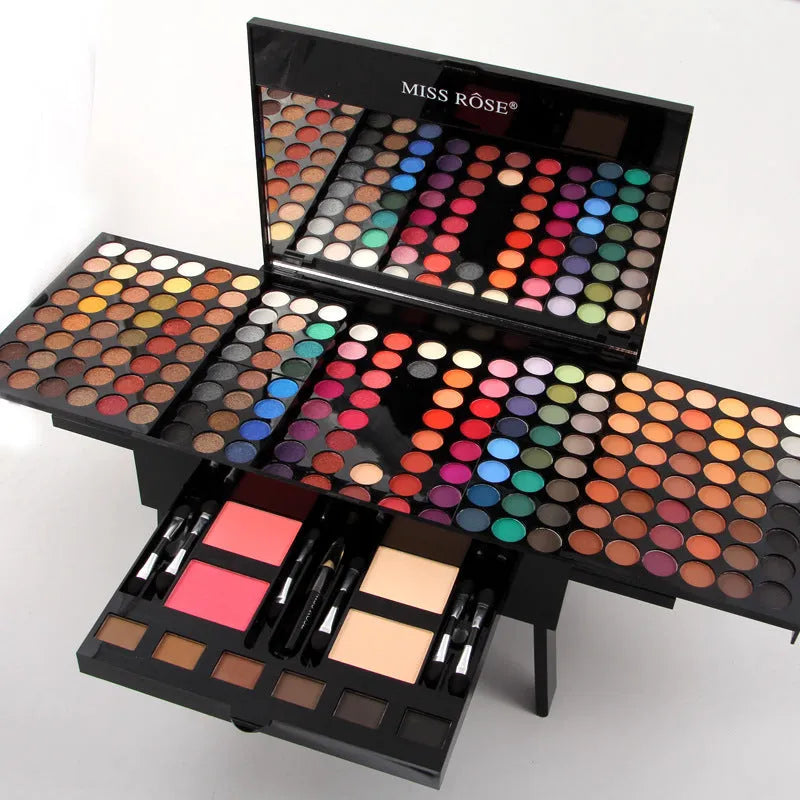 Piano-shaped open makeup palette displaying 180 eyeshadow colours, 2 blushes, 2 powders, and 6 powder outlines.