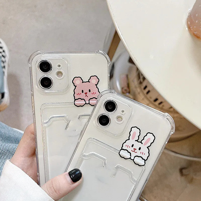 Transparent cartoon card holder phone case for Apple iPhone on a table.