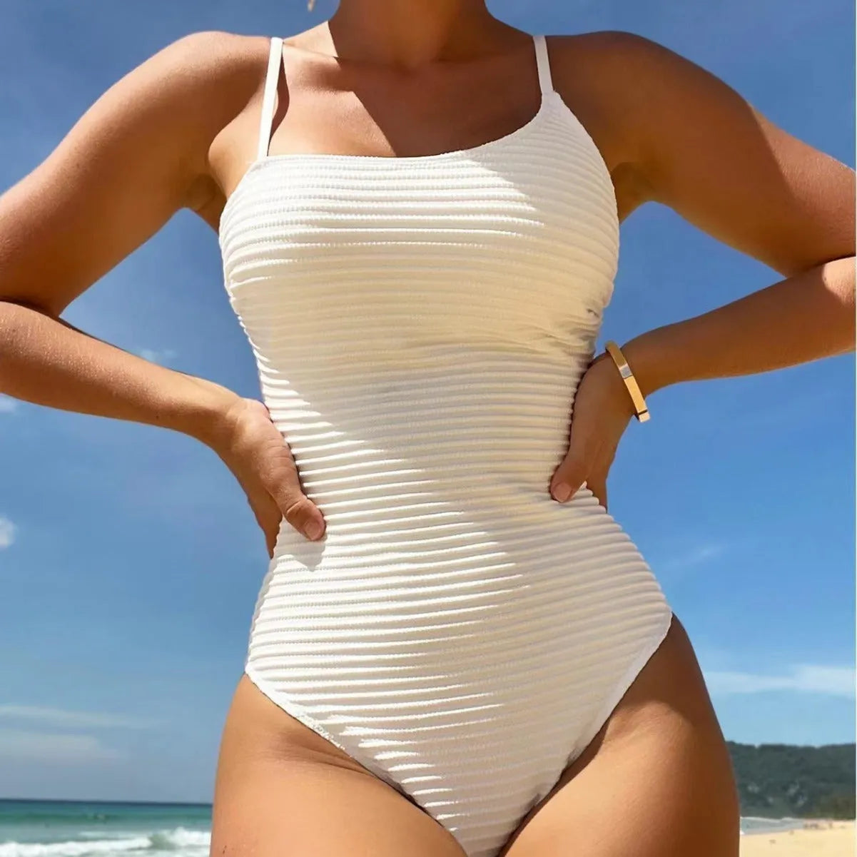 Conservative solid colour one-piece swimsuit with spaghetti straps on a mannequin
