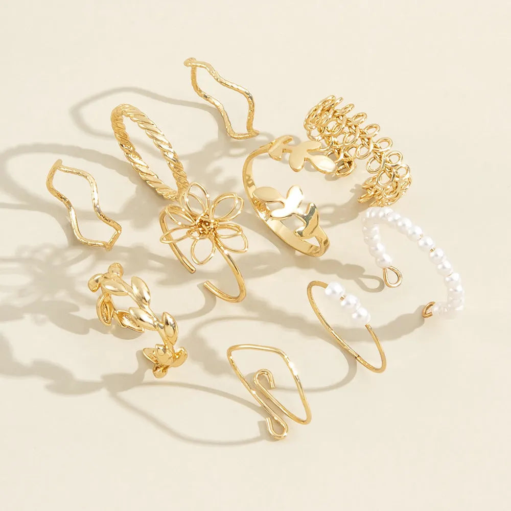 Gold-coloured openwork flower ring made from alloy with a glossy electroplated finish.