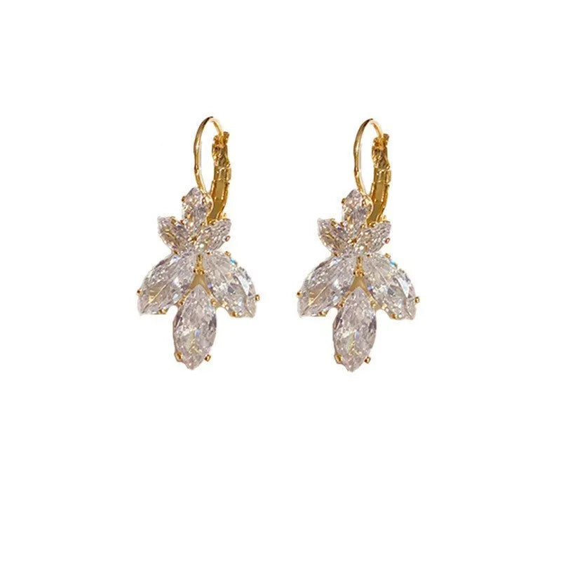 Platinum colour leaf-shaped drop earrings with shiny inlaid zircon details for women.