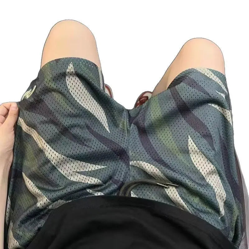 Men's camouflage pattern cotton blend straight-leg mesh shorts laid flat.