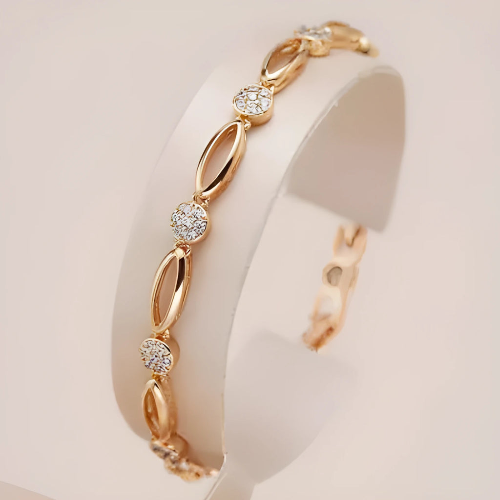 Golden hollow carved copper bracelet in a U-shape for women, showing detailed openwork design.