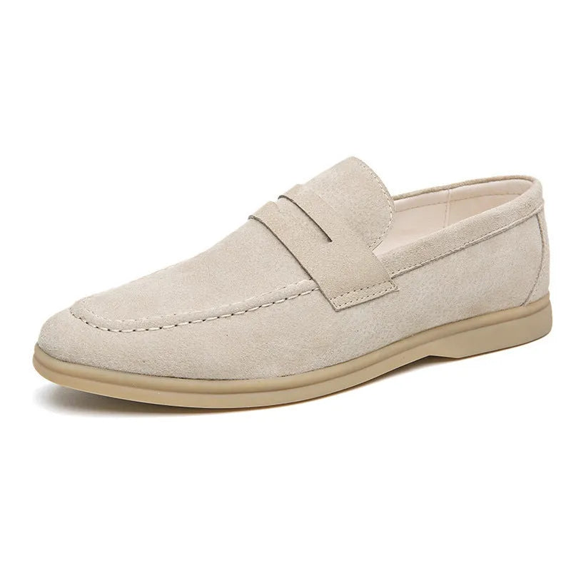 Men's beige leather slip-on casual shoes with round toe and rubber sole on a white background.