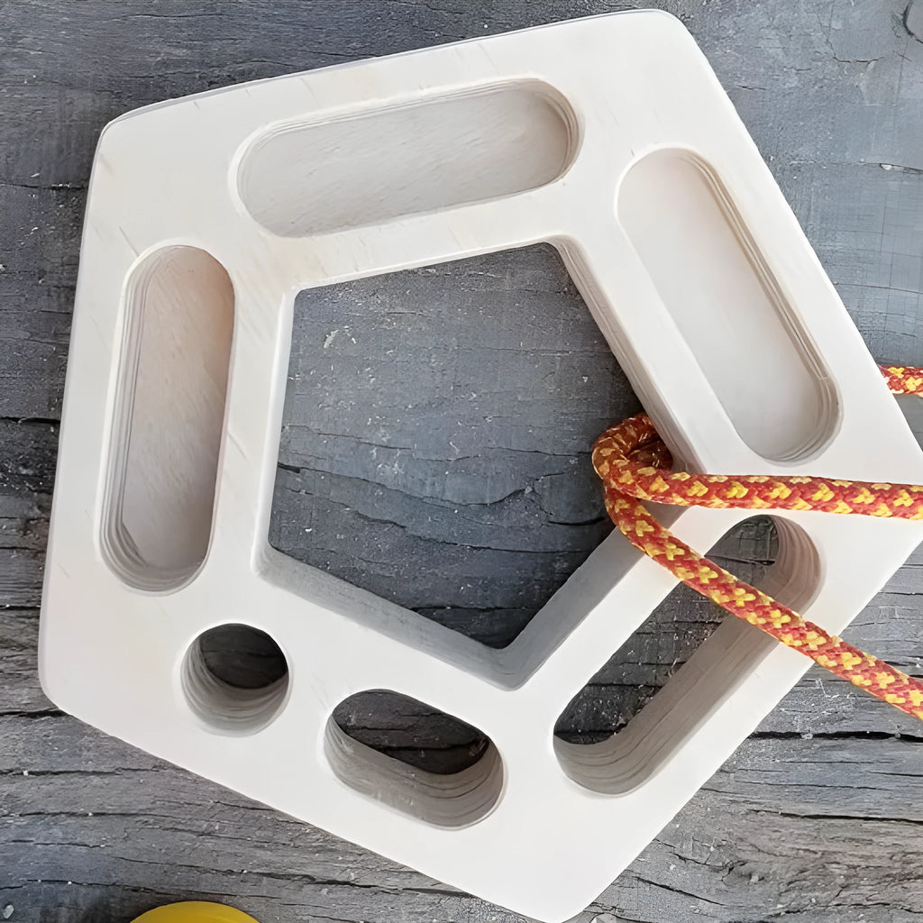 Birch wooden pentagonal-round climbing finger force training plate on a neutral background.