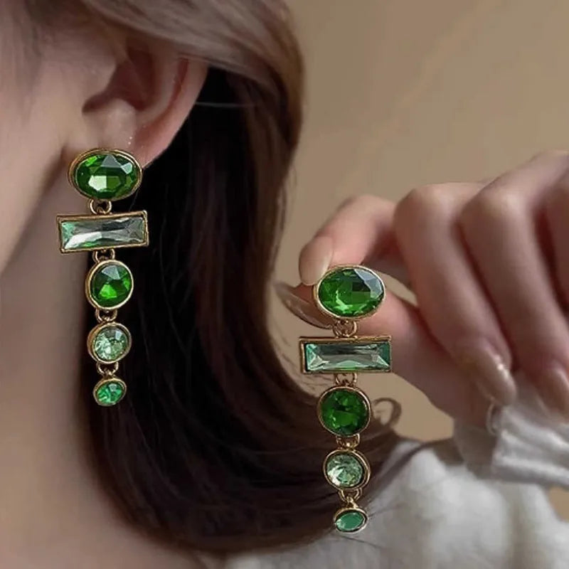 A pair of green gradient retro earrings with a geometric shape, tassel detail, and zircon inlay on an alloy base.