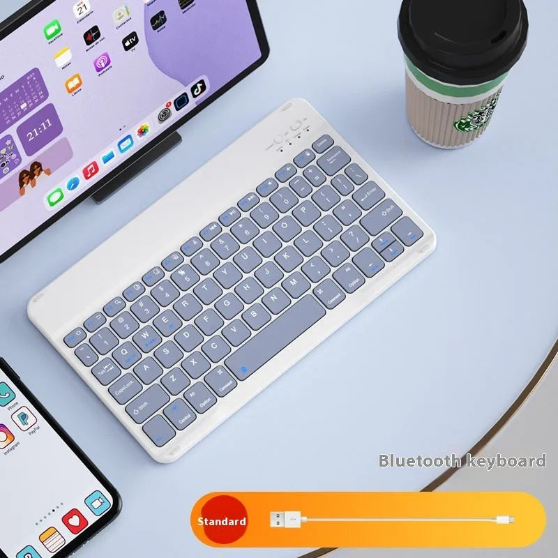 Girls Bluetooth keyboard in Lavender colour on a desk next to a tablet