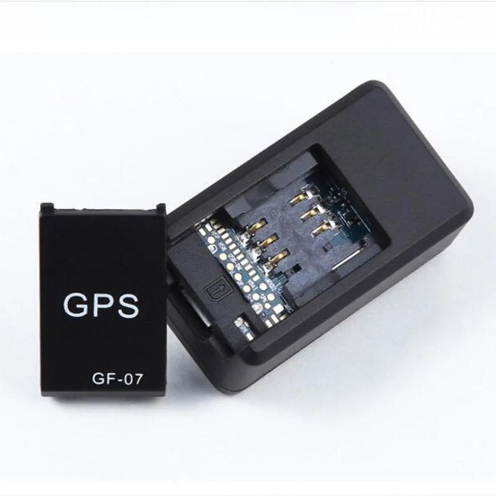 Small black magnetic GPS tracker device shown next to a USB charging cable.