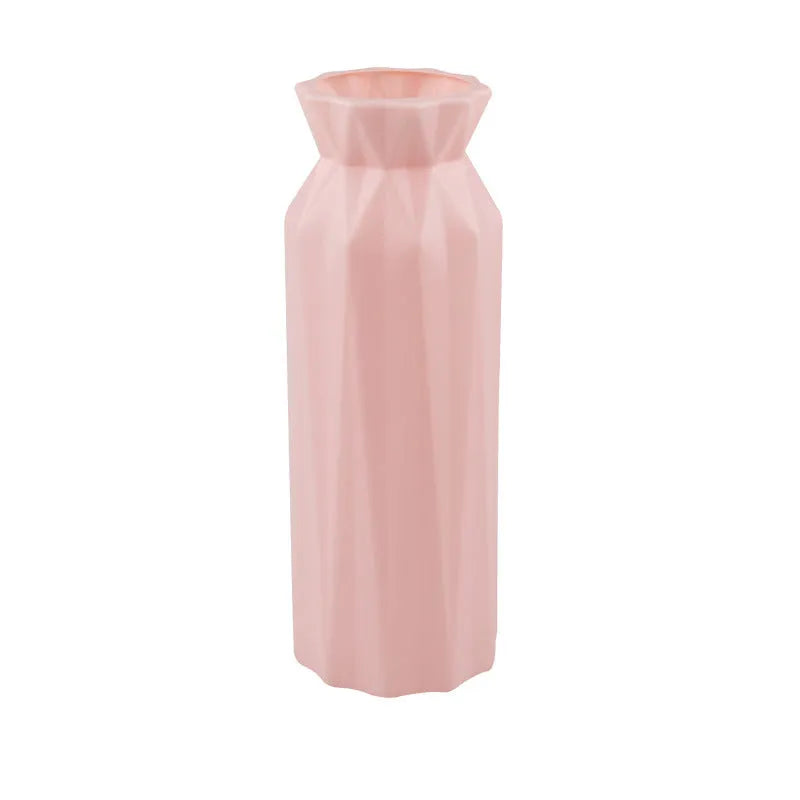 A green drop-resistant plastic melamine vase with a wide 7.2cm base on a wooden table.