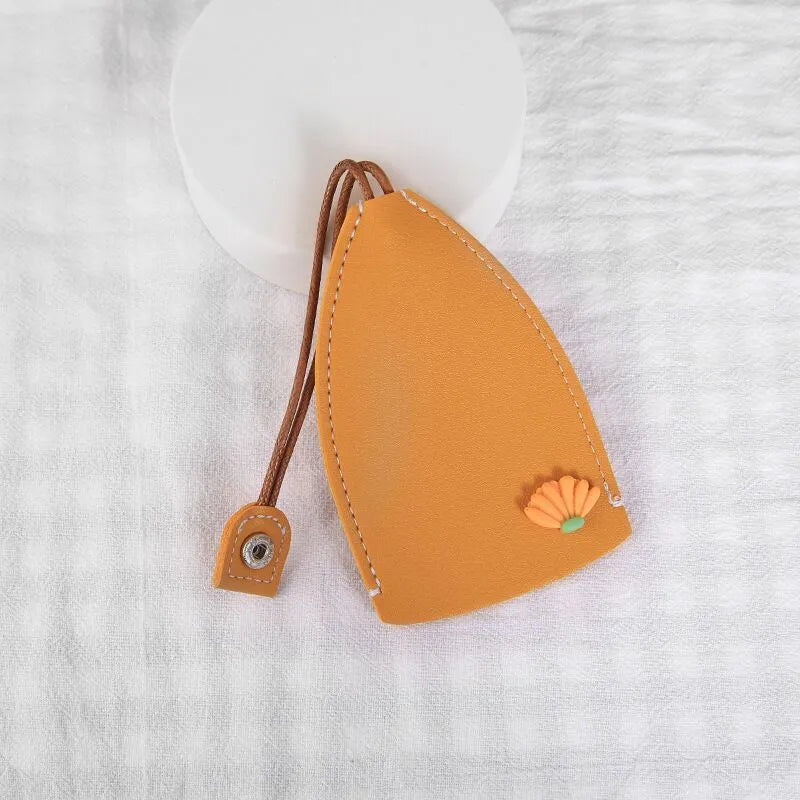 Cartoon pull-out key case in PU leather measuring 14 x 7.5 cm with colourful designs