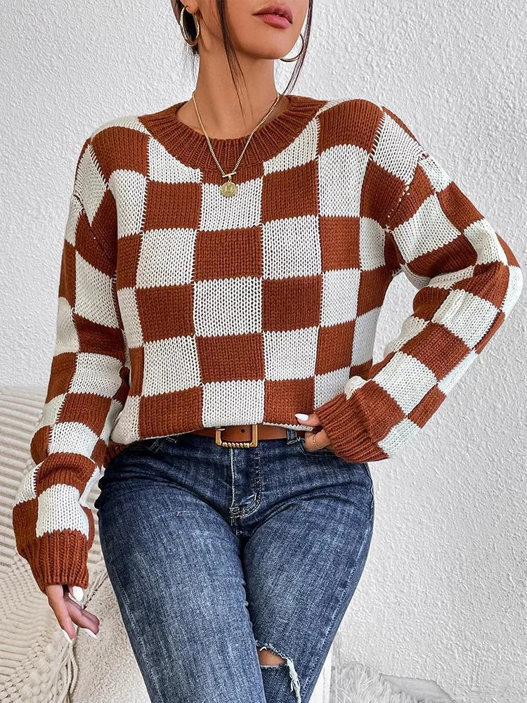 Dark brown plaid pattern on a loose round neck acrylic pullover sweater with long sleeves.